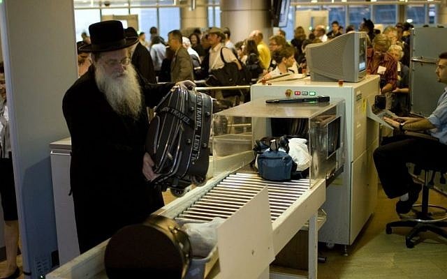 illustrative: Passengers have their hand luggage screened by security personnel at Ben-Gurion Airport, file photo (Ariel Schalit/AP) illustrative: Passengers have their hand luggage screened by security personnel at Ben-Gurion Airport, file photo (Ariel Schalit/AP)