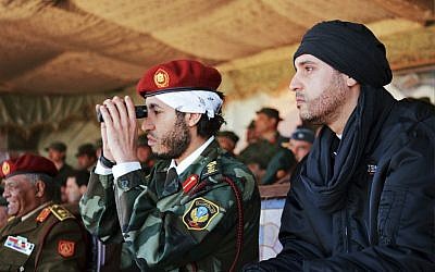 Al-Saadi Gaddafi, in uniform, and his brother Hannibal Gaddafi, right, watch a military exercise in an undated photo released in 2011. (photo credit: AP/Abdel Magid al-Fergany)