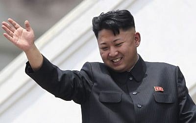 North Korean leader Kim Jong Un waves during a mass military parade, July 27, 2013. (photo credit: AP/Wong Maye-E)