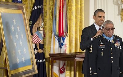 US President Barack Obama awards Army Staff Sgt. Melvin Morris the Medal of Honor during a ceremony in the East Room of the White House in Washington, on Tuesday (photo credit: AP/Manuel Balce Ceneta)