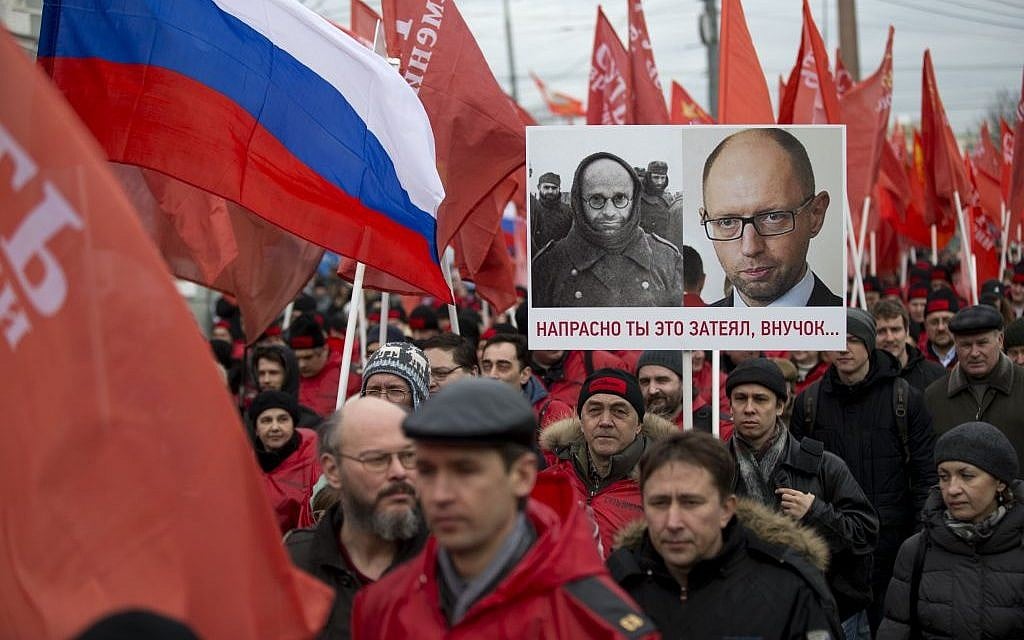 Demonstrators march in support of Kremlin-backed plans for the Ukrainian province of Crimea to break away and merge with Russia, in Moscow, Saturday, March 15, 2014. A poster depicts photos of a WWII German prisoner of war and Ukrainian Prime Minister Arseniy Atsenyuk, and says 'Your project is doomed, grandson' (AP Photo/Alexander Zemlianichenko) Demonstrators march in support of Kremlin-backed plans for the Ukrainian province of Crimea to break away and merge with Russia, in Moscow, Saturday, March 15, 2014. A poster depicts photos of a WWII German prisoner of war and Ukrainian Prime Minister Arseniy Atsenyuk, and says 'Your project is doomed, grandson' (AP Photo/Alexander Zemlianichenko)