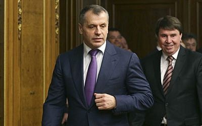 Crimea's prime minister Sergei Aksyonov, center, enters a hall prior to talks in the Russian Parliament in Moscow, Friday, March 7, 2014. (AP Photo/Alexander Shalgin)