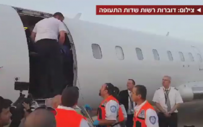 Emergency medical personnel at Tel Aviv's Ben Gurion Airport prepare to receive the wounded from Kiev on Friday (photo credit: screenshot via Channel 2)
