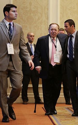 Sheldon Adelson, center, arrives at the Republican Jewish Coalition as New Jersey Gov. Chris Christie speaks, Saturday, March 29, 2014, in Las Vegas (photo credit: AP/Julie Jacobson)