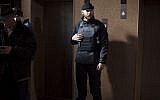 A Right Sector member stands guard next to elevators on the ground floor of the Dnipro hotel near Independence Square, Kiev, Ukraine, on March 7, 2014 (photo credit: AP/David Azia)