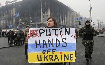 A woman holds a poster against war at Kiev's Independence Square, in Ukraine, Thursday, March 6, 2014.  (photo credit: AP/Efrem Lukatsky)