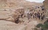 Spectators scurry out of the path of the Negev's Zin River as it roars to life (screen capture: YouTube)