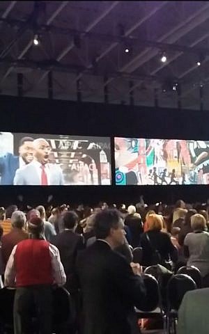 AIPAC delegates grooving to gospel tune 'Walk With Me,' sung by Chris Harris and co., on screen at center, at the convention Sunday. (screen capture: YouTube)