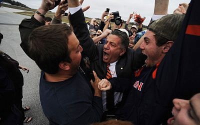 New Auburn basketball coach Bruce Pearl engulfed by adoring fans upon arriving at the Auburn University Regional Airport on his 54th birthday, March 18, 2014. (Courtesy Auburn University/Zach Bland/JTA)