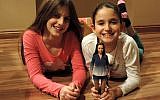Nickolay Lamm's cousins play with a prototype of the Lammily doll. (photo credit: JTA, courtesy of Nickolay Lamm)