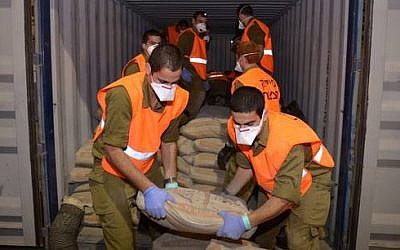Israeli soldiers unload cargo found on the Klos-C. (photo credit: IDF Spokesperson)