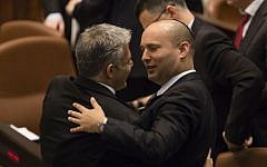 Jewish Home's Naftali Bennett seen with Yesh Atid's Yair Lapid, after the Draft law passed unanimously in the Knesset, March 12, 2014. (Flash90)