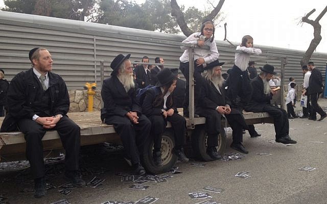 A group of ultra-Orthodox men and boys wait for the rally to start (photo credit: Mitch Ginsburg/Times of Israel)