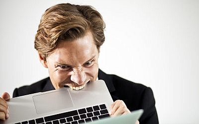 A frustrated reader of the Onion (laptop image via Shutterstock)