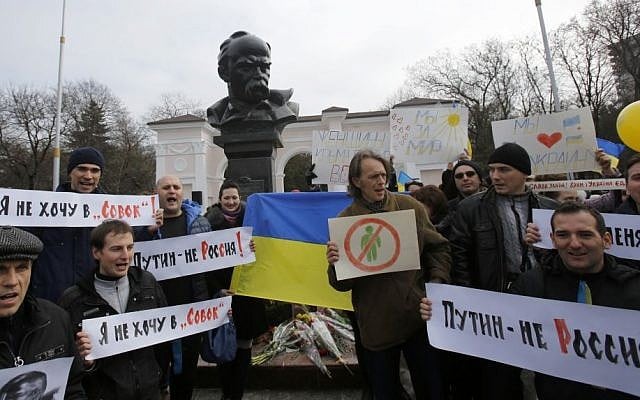 People shout slogans as they stand next to a statue of Ukrainian poet Taras Shevchenko, during a rally against the breakup of the country in Simferopol, Crimea, Ukraine, Thursday, March 9, 2014. (photo credit: AP Photo/Darko Vojinovic) People shout slogans as they stand next to a statue of Ukrainian poet Taras Shevchenko, during a rally against the breakup of the country in Simferopol, Crimea, Ukraine, Thursday, March 9, 2014. (photo credit: AP Photo/Darko Vojinovic)