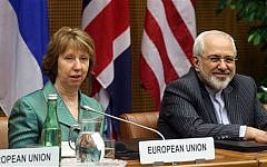 European Union foreign policy chief Catherine Ashton, left, and Iranian Foreign Minister Mohamad Javad Zarif, right, wait for the start of closed-door nuclear talks in Vienna, Tuesday, March 18, 2014 (photo credit: AP/Ronald Zak)