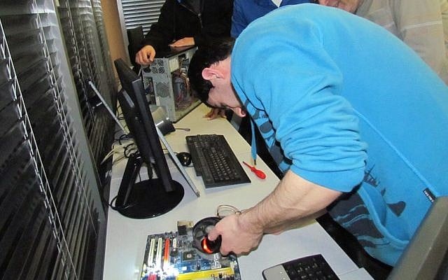 A John Bryce students works on a computer, which will eventually find its way to the home of a needy child (Photo credit: Courtesy) A John Bryce students works on a computer, which will eventually find its way to the home of a needy child (Photo credit: Courtesy)