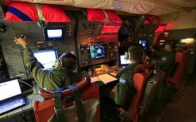 Australian Defence handout photo taken on April 1, 2014, and released on April 3, shows crew members on board an RAAF Orion during the search for missing Malaysia Airlines Flight MH370 in the southern Indian Ocean. (photo credit: AFP/Australian Defence/Cpl David Gibbs)