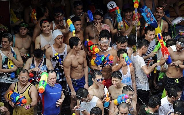 People take part in water battles in Bangkok as they celebrate Songkran, the festival that marks Thailand's New Year, on April 13, 2014. (photo credit: AFP/Christophe Archambault) People take part in water battles in Bangkok as they celebrate Songkran, the festival that marks Thailand's New Year, on April 13, 2014. (photo credit: AFP/Christophe Archambault)