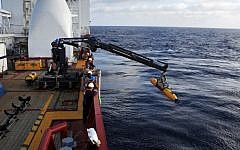 Operators aboard ADF Ocean Shield moving US Navy’s Bluefin-21 into position for deployment in the search for missing Malaysia Airlines Flight MH370,  April 14, 2014. (photo credit: AFP/Mass Communication Specialist 1st Class Peter D. Blair/US Navy)