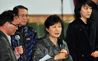 South Korea's President Park Geun-Hye (C) speaks during a visit to relatives of missing passengers on board a capsized ferry as they wait for updates about their loved ones at a gym in Jindo on April 17, 2014. (Jung Yeon-Je/AFP)
