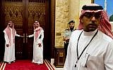 Aides to Saudi King Abdullah stand outside a room in the monarch's desert camp about 60 kilometers northeast of Riyadh while he meets with US President Barack Obama, March 2014. (photo credit: Saul Loeb/AFP)