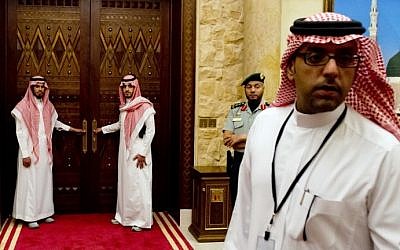 Aides to Saudi King Abdullah stand outside a room in the monarch's desert camp about 60 kilometers northeast of Riyadh while he meets with US President Barack Obama, March 2014. (photo credit: Saul Loeb/AFP)