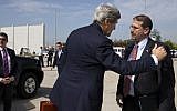 Then-US Secretary of State John Kerry (L) greets Then-US Ambassador to Israel Daniel Shapiro before boarding a plane while leaving Ben Gurion Airport after a meeting with Prime Minister Benjamin Netanyahu, Tuesday, April 1, 2014. (Jacquelyn Martin/AFP)