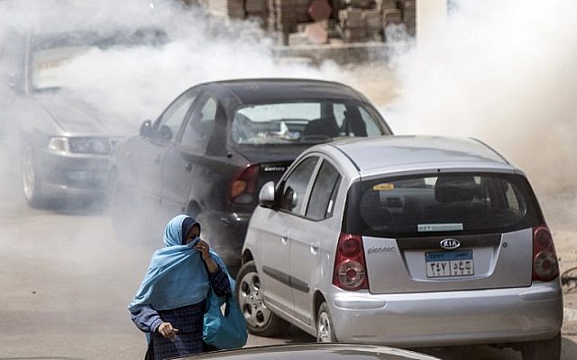 An Egyptian woman runs for cover as tear gas is fired by Egyptian riot police during clashes with students, supporters of the Muslim Brotherhood and ousted Islamist president Mohamed Morsi, April 9, 2014. (AFP/MAHMOUD KHALED) An Egyptian woman runs for cover as tear gas is fired by Egyptian riot police during clashes with students, supporters of the Muslim Brotherhood and ousted Islamist president Mohamed Morsi, April 9, 2014. (AFP/MAHMOUD KHALED)