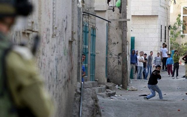 A Palestinian protester uses a slingshot to hurl stones towards Israeli security forces during clashes at the Aida Palestinian refugee camp near Bethlehem on April 14, 2014. (Musa al-Shaer/AFP) A Palestinian protester uses a slingshot to hurl stones towards Israeli security forces during clashes at the Aida Palestinian refugee camp near Bethlehem on April 14, 2014. (Musa al-Shaer/AFP)