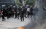 Egyptian riot police disperse students who support the Muslim Brotherhood and ousted Islamist president Mohamed Morsi, during clashes following a demonstration at the Cairo University on April 15, 2014. (AFP/Mahmoud Khaled/File)