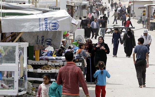 Syrian refugees walks past a makeshift market in the Zaatari refugee camp, on April 15, 2014. (AFP/Khalil Mazraawi) Syrian refugees walks past a makeshift market in the Zaatari refugee camp, on April 15, 2014. (AFP/Khalil Mazraawi)