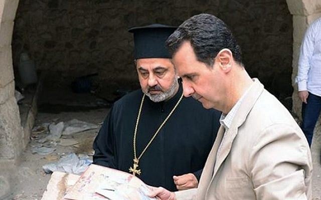 A picture uploaded on the official Facebook page of the Syrian Presidency on April 20, 2014, shows Syria's President Bashar al-Assad looking at icons as he visits a monastery in the ancient Christian town of Maalula which his troops recently recaptured from rebels. (photo credit: AFP PHOTO / HO / SYRIAN PRESIDENCY FACEBOOK PAGE) A picture uploaded on the official Facebook page of the Syrian Presidency on April 20, 2014, shows Syria's President Bashar al-Assad looking at icons as he visits a monastery in the ancient Christian town of Maalula which his troops recently recaptured from rebels. (photo credit: AFP PHOTO / HO / SYRIAN PRESIDENCY FACEBOOK PAGE)