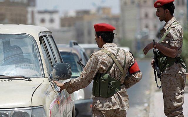 Yemeni soldiers stand guard in the capital Sanaa on April 20, 2014, and check passing vehicles as authorities tightened security measures a day after a US drone killed 15 al-Qaeda suspects (photo credit: AFP/Mohammed Huwais) Yemeni soldiers stand guard in the capital Sanaa on April 20, 2014, and check passing vehicles as authorities tightened security measures a day after a US drone killed 15 al-Qaeda suspects (photo credit: AFP/Mohammed Huwais)
