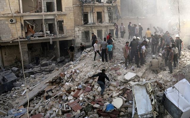 People inspect the rubble after a building collapsed following a reported bombardment with explosive-packed "barrel bombs" by Syrian government forces in the al-Mowasalat neighborhood of the northern Syrian city of Aleppo, on April 27, 2014. (AFP Photo/Aleppo Media Centre/Zein al Rifai) People inspect the rubble after a building collapsed following a reported bombardment with explosive-packed "barrel bombs" by Syrian government forces in the al-Mowasalat neighborhood of the northern Syrian city of Aleppo, on April 27, 2014. (AFP Photo/Aleppo Media Centre/Zein al Rifai)