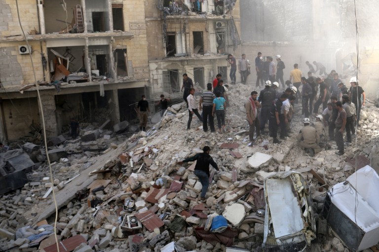 People inspect the rubble after a building collapsed following a reported bombardment with explosive-packed "barrel bombs" by Syrian government forces in the al-Mowasalat neighborhood of the northern Syrian city of Aleppo, on April 27, 2014. (photo credit: AFP Photo/Aleppo Media Centre/Zein al Rifai) People inspect the rubble after a building collapsed following a reported bombardment with explosive-packed "barrel bombs" by Syrian government forces in the al-Mowasalat neighborhood of the northern Syrian city of Aleppo, on April 27, 2014. (photo credit: AFP Photo/Aleppo Media Centre/Zein al Rifai)