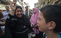 Egyptians react outside the courtroom in Egypt's southern province of Minya on April 28, 2014.  (photo credit:AFP/KHALED DESOUKI)