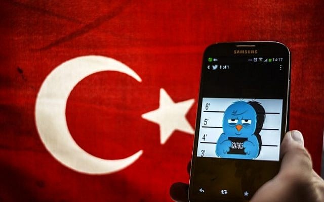 This file picture dated on March 26, 2014, shows a picture representing a mugshot of the Twitter bird seen on a smartphone with a Turkish flag in Istanbul. (AFP/Ozan Kose) This file picture dated on March 26, 2014, shows a picture representing a mugshot of the Twitter bird seen on a smartphone with a Turkish flag in Istanbul. (AFP/Ozan Kose)