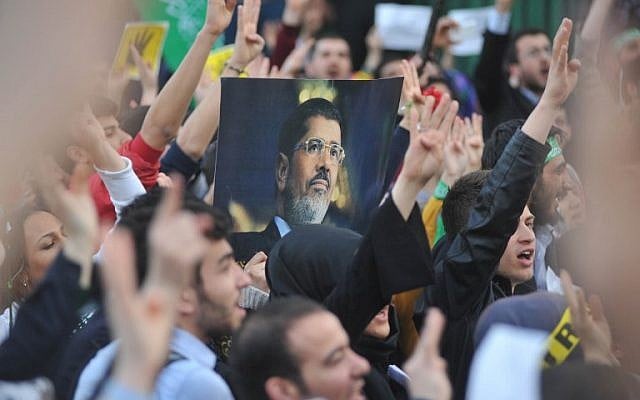 - Supporters of the Egyptian Muslim Brotherhood hold a portrait of of deposed president Mohammed Morsi as they take part in a rally to protest against the death penalties for the members of the radical group in Egypt, outside the Egyptian embassy in Ankara on April 9, 2014. A court in Egypt on March 29 sentenced to death two supporters of deposed president Mohamed Morsi convicted of throwing youths off an apartment block roof, judicial sources said. The latest death sentences come despite international outcry at Egypt handing down the death penalty to 529 Islamists. (AFP PHOTO / ADEM ALTAN)