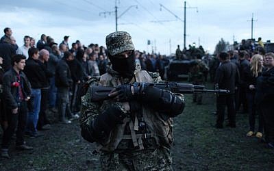 Armed pro-Russia activists block a column of Ukrainian men riding on Armored Personnel Carriers in the eastern Ukrainian city of Kramatorsk on April 16, 2014.  (photo credit: AFP/ANATOLIY STEPANOV)