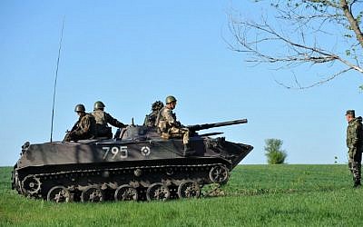 Ukrainian soldiers sit in a tank at their newly erected checkpoint near the eastern Ukrainain city of Slavyansk on April 25, 2014. (photo credit: AFP/Genya Savilov)