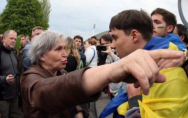 An elderly pro-Russian woman gestures and argues with a young man wearing a Ukrainian flag during a rally for national unity in the eastern Ukrainan city of Donetsk on April 28, 2014. (photo credit: AFP/Alexander Khudoteply) An elderly pro-Russian woman gestures and argues with a young man wearing a Ukrainian flag during a rally for national unity in the eastern Ukrainan city of Donetsk on April 28, 2014. (photo credit: AFP/Alexander Khudoteply)