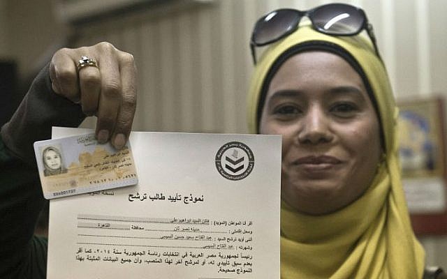 An Egyptian woman poses in Cairo on March 31, 2014 with her ID and a document that she has signed to support the candidacy of former army chief Abdelfatah al-Sissi to run in the presidential elections to be held on May 26-27. (photo credit: AFP/ KHALED DESOUKI) An Egyptian woman poses in Cairo on March 31, 2014 with her ID and a document that she has signed to support the candidacy of former army chief Abdelfatah al-Sissi to run in the presidential elections to be held on May 26-27. (photo credit: AFP/ KHALED DESOUKI)