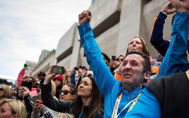 People cheer as Meb Keflezighi, an American, wins the Boston Marathon on April 21, 2014 in Boston, Massachusetts (Photo credit: Andrew Burton/Getty Images North America/AFP) People cheer as Meb Keflezighi, an American, wins the Boston Marathon on April 21, 2014 in Boston, Massachusetts (Photo credit: Andrew Burton/Getty Images North America/AFP)
