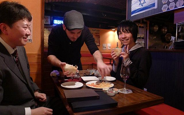 Roy Somech, center, with two Japanese patrons. (photo credit: Courtesy of Roy Somech/Facebook)