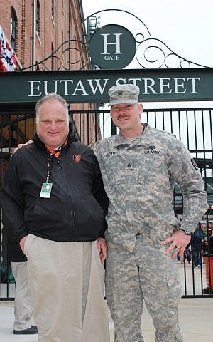 Robert Schapiro, left, and Sgt. Nicholas McCulley, to whom he had given a ticket for the day's game, April 3, 2014. (Hillel Kuttler via JTA)