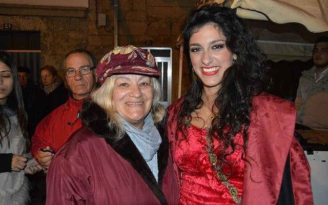 The Israeli Ladino performer Mor Karbasi right with Maria Tavares, a native of Medelim in Portugal, at the town's Jewish and Christian Passover celebration last month. (Beira Baixa TV via JTA)