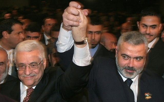 Palestinian Authority President Mahmoud Abbas, left, and then Hamas prime minister Ismail Haniyeh, right, raise their linked arms as they move through the crowd at a special session of parliament in Gaza City, March 17, 2007. (AP/Hatem Moussa/File) Palestinian Authority President Mahmoud Abbas, left, and then Hamas prime minister Ismail Haniyeh, right, raise their linked arms as they move through the crowd at a special session of parliament in Gaza City, March 17, 2007. (AP/Hatem Moussa/File)