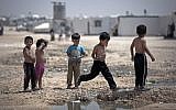 File: Syrian children play under the heat of the midday sun in the Zaatari refugee camp in Jordan, near the Syrian border, on April 17, 2014. (AP/Khalil Hamra)