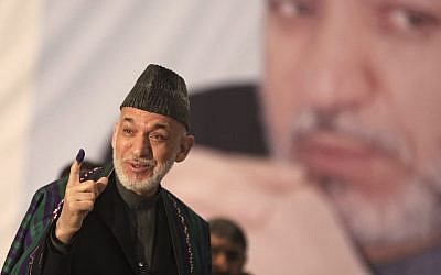 Afghan President Hamid Karzai shows indelible ink on his finger to the media before he casts his vote at Amani High School, near the presidential palace in Kabul, Afghanistan, on Saturday, April 5, 2014. (photo credit: AP Photo/Massoud Hossaini) Afghan President Hamid Karzai shows indelible ink on his finger to the media before he casts his vote at Amani High School, near the presidential palace in Kabul, Afghanistan, on Saturday, April 5, 2014. (photo credit: AP Photo/Massoud Hossaini)
